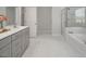 Bright bathroom with a glass enclosed shower, soaking tub, and a gray vanity at 117 Gravel Brook Ct, Cary, NC 27519