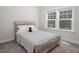 Cozy bedroom with a stylish bed, soft carpet, and natural light from the windows at 117 Gravel Brook Ct, Cary, NC 27519