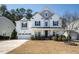 Charming two-story home featuring a manicured lawn and an attached two-car garage at 117 Gravel Brook Ct, Cary, NC 27519