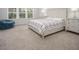 Bright primary bedroom with large windows, plush carpet, and contemporary furniture at 117 Gravel Brook Ct, Cary, NC 27519