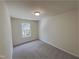Neutrally painted bedroom featuring carpeted floors and a window overlooking the trees outside at 11700 Coppergate Dr # 105, Raleigh, NC 27614