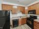 Well-equipped kitchen with wood cabinets and modern appliances at 11700 Coppergate Dr # 105, Raleigh, NC 27614