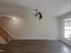Expansive living area features hardwood floors, ceiling fan, and stairs to the upper level at 11700 Coppergate Dr # 105, Raleigh, NC 27614