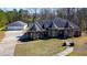 Spacious home with attached garage, circular driveway, and lush greenery at 119 Cardinal Crest Ct, Pittsboro, NC 27312