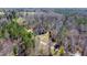A beautiful home with a circular driveway surrounded by lush greenery and tall trees at 119 Cardinal Crest Ct, Pittsboro, NC 27312