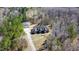 A beautiful home with a circular driveway surrounded by lush greenery and tall trees at 119 Cardinal Crest Ct, Pittsboro, NC 27312