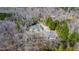 A beautiful home with a circular driveway surrounded by lush greenery and tall trees at 119 Cardinal Crest Ct, Pittsboro, NC 27312