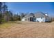 Large backyard featuring lush grass and trees at 119 Cardinal Crest Ct, Pittsboro, NC 27312