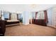 This bedroom boasts a neutral carpet, natural light, and an ensuite bathroom and access to the outdoors at 119 Cardinal Crest Ct, Pittsboro, NC 27312