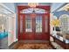 Elegant entryway features wood doors, transom window, chandelier, and decorative rug at 119 Cardinal Crest Ct, Pittsboro, NC 27312