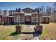 Beautiful brick home with arched windows and a well-manicured lawn at 119 Cardinal Crest Ct, Pittsboro, NC 27312