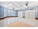 Bright garage with multiple windows, brick accents, and spacious area with three white garage doors at 119 Cardinal Crest Ct, Pittsboro, NC 27312
