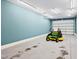 Spacious garage with a lawnmower, featuring ample lighting and a clean, modern finish at 119 Cardinal Crest Ct, Pittsboro, NC 27312