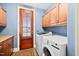 Laundry room with wood cabinets, counterspace and included washer and dryer at 119 Cardinal Crest Ct, Pittsboro, NC 27312