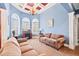 Inviting living room with coffered ceilings, arched windows, and comfortable seating at 119 Cardinal Crest Ct, Pittsboro, NC 27312