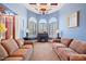 Inviting living room with coffered ceilings, arched windows, and comfortable seating at 119 Cardinal Crest Ct, Pittsboro, NC 27312