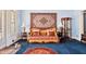 Cozy living room with plush blue carpeting, designer sofa, and unique wall tapestry at 119 Cardinal Crest Ct, Pittsboro, NC 27312