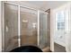 Glass enclosed shower in the bathroom with tiled floor and walls, and nearby window with shutter at 119 Cardinal Crest Ct, Pittsboro, NC 27312
