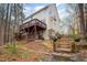 Charming home featuring a spacious back deck and landscaped backyard with wooden steps and mature trees at 12 Montcrest Dr, Durham, NC 27713