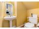 This cozy half bathroom features a pedestal sink and yellow walls at 12 Montcrest Dr, Durham, NC 27713