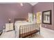 Cozy bedroom with iron frame bed, bedside tables and ensuite bathroom entrance; naturally lit with a ceiling fan overhead at 12 Montcrest Dr, Durham, NC 27713