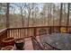 The outdoor deck has a table and chairs with views of the surrounding woods at 12 Montcrest Dr, Durham, NC 27713