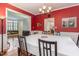 Formal dining room with hardwood floors, a chandelier, and views into the living areas at 12 Montcrest Dr, Durham, NC 27713