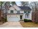 Charming two-story home featuring a green door, green shutters, and attached two-car garage at 12 Montcrest Dr, Durham, NC 27713