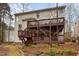Back exterior view of a two-story home with a large deck and landscaped backyard at 12 Montcrest Dr, Durham, NC 27713