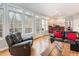 Bright living room featuring large windows, hardwood floors, and views into kitchen and dining area at 12 Montcrest Dr, Durham, NC 27713