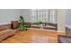 Cozy sitting area with hardwood floors, lots of plants, and a bay window with shutters at 12 Montcrest Dr, Durham, NC 27713