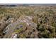 An aerial view of the neighborhood with mature trees and various commercial areas at 122 W Woodridge Dr, Durham, NC 27707
