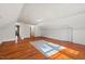 Finished attic featuring hardwood floors, a rug, and great lighting at 122 W Woodridge Dr, Durham, NC 27707