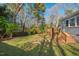Backyard with grass, swing, and a firepit viewed from a deck at 122 W Woodridge Dr, Durham, NC 27707