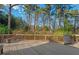 Wide backyard deck with wood railings, grill, greenery in the background, and trees at 122 W Woodridge Dr, Durham, NC 27707