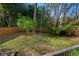 Grassy backyard featuring a swing hanging from a tree at 122 W Woodridge Dr, Durham, NC 27707