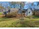 View of house and backyard with wooden deck, swing, and fire pit at 122 W Woodridge Dr, Durham, NC 27707
