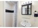 Bathroom features a tiled shower, stylish vanity, and modern fixtures at 122 W Woodridge Dr, Durham, NC 27707