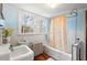 The bathroom has vintage fixtures, natural light, and a charming ambiance at 122 W Woodridge Dr, Durham, NC 27707