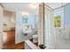 The bathroom features blue walls, a sink, toilet, and a tub with a patterned shower curtain at 122 W Woodridge Dr, Durham, NC 27707