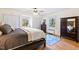 Comfortable bedroom with large windows, hardwood floors, and natural light at 122 W Woodridge Dr, Durham, NC 27707