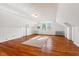 An upstairs bonus room is illuminated by a window and contains hardwood floors at 122 W Woodridge Dr, Durham, NC 27707