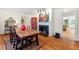 Elegant dining room with a large table, fireplace, and hardwood floors at 122 W Woodridge Dr, Durham, NC 27707
