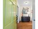 Inviting entryway with hardwood floors, complemented by a modern console table and bright green door at 122 W Woodridge Dr, Durham, NC 27707