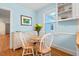 Kitchen nook with round table, white chairs, and a sunlit window at 122 W Woodridge Dr, Durham, NC 27707