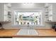 Sunlit kitchen featuring butcher block countertops, white tile backsplash, and shelving at 122 W Woodridge Dr, Durham, NC 27707