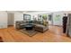 Spacious living room with hardwood floors, a large sectional sofa, and bright natural light at 122 W Woodridge Dr, Durham, NC 27707