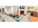 Spacious living room with large sectional sofa, fireplace, and hardwood floors at 122 W Woodridge Dr, Durham, NC 27707