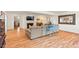 Open living room featuring hardwood floors, comfortable seating, and a stylish fireplace, perfect for entertaining at 122 W Woodridge Dr, Durham, NC 27707