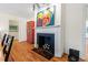 Bright living room with hardwood floors, fireplace, and artistic decor at 122 W Woodridge Dr, Durham, NC 27707